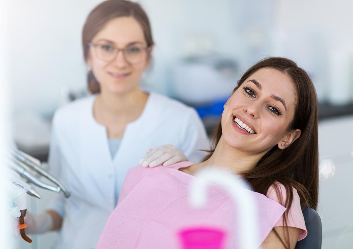 Woman and dentist smiling together